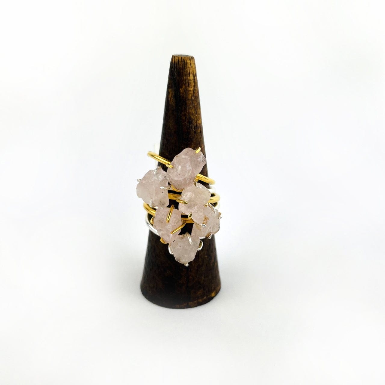 Rose Quartz Gemstone Rings in Gold and Silver stacked on display
