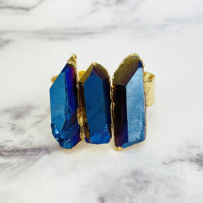 up close shot of Titanium Crystal Quartz Triple Point Cuff Bracelet with Electroplated 24k Gold on marble background