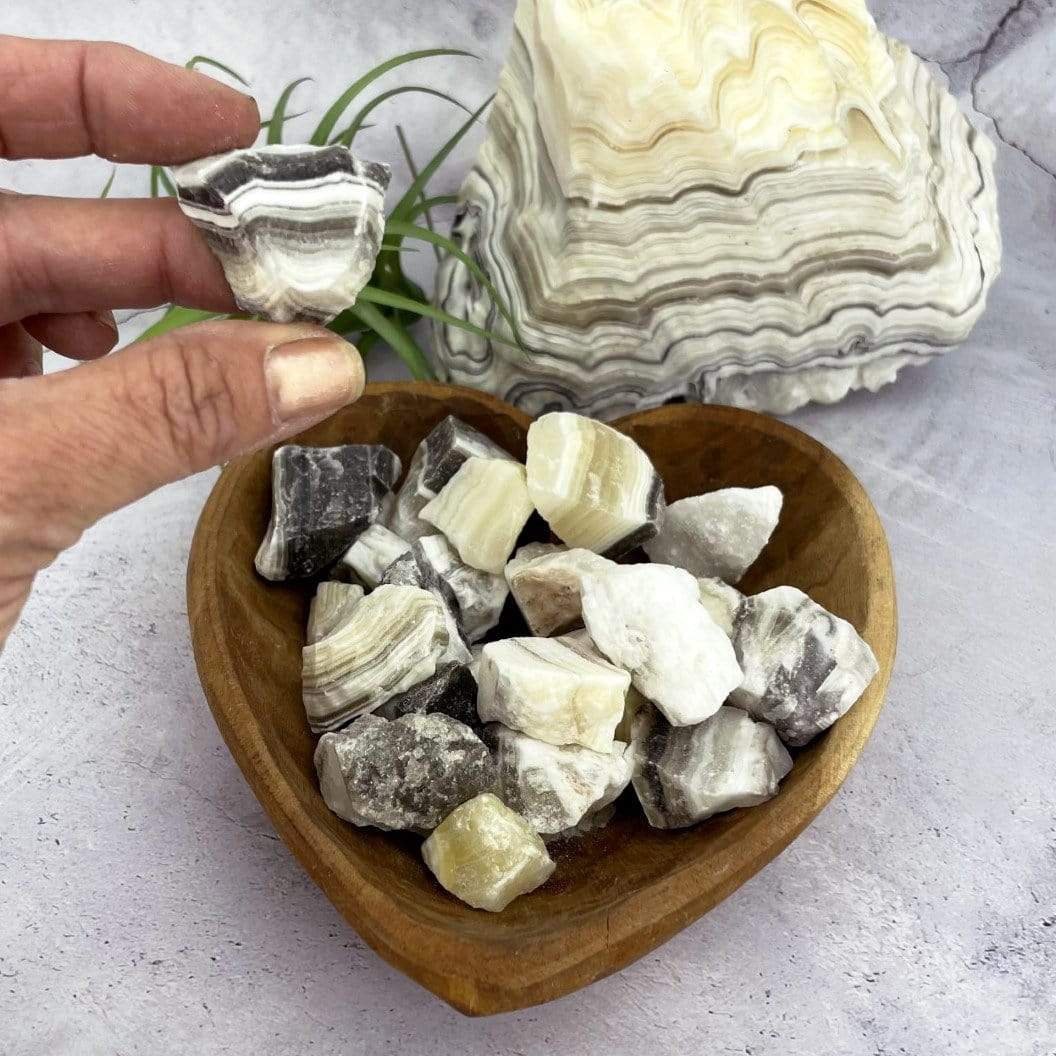 Mexican onyx stones displayed in hand and in a heart shape bowl (bowl not included).