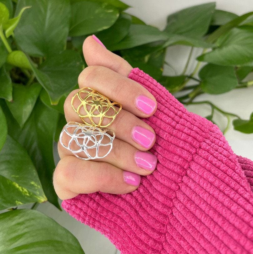 Seed of Life Ring in gold and silver on a hand for size