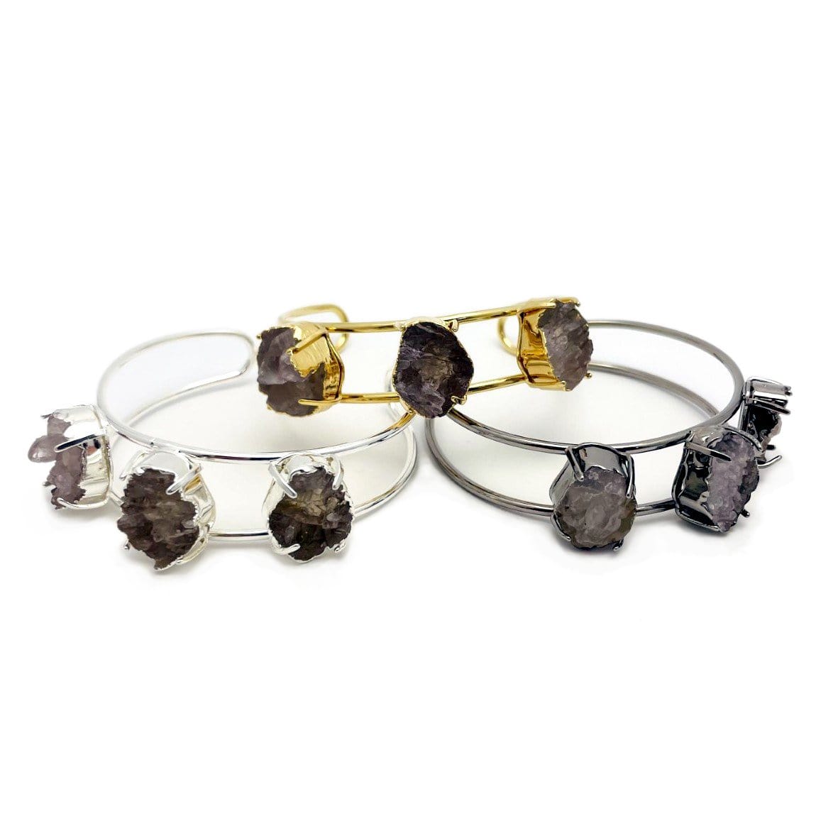 Druzy cuff bracelets in gold plating, silver plating and gunmetal plating on a white background.