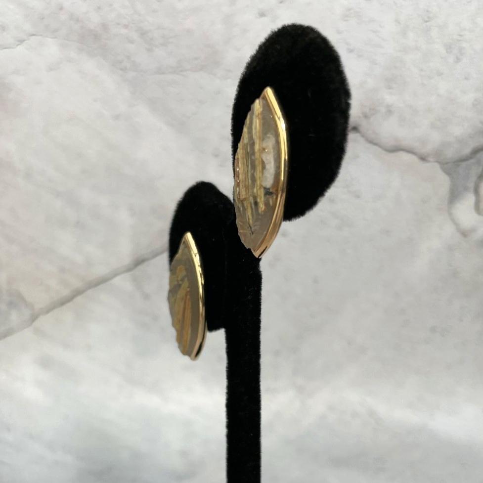 side view of Rutilated Quartz Stud Earrings on earring stand