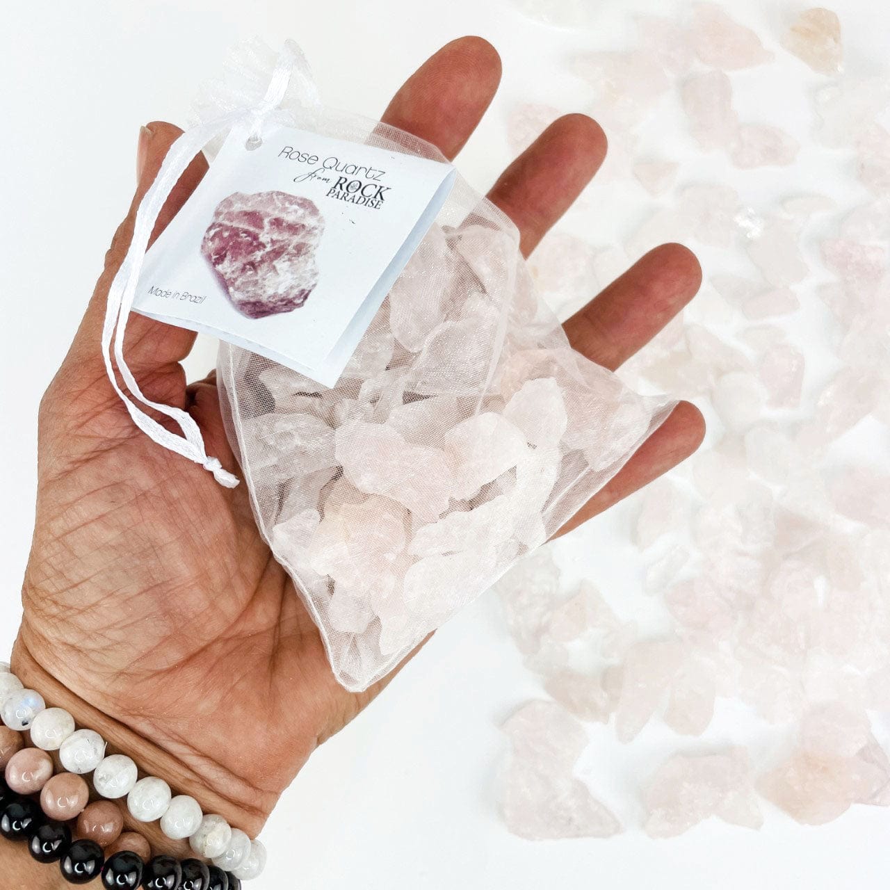 Rose Quartz Stones - Tied & Tagged in an Organza Bag in a hand