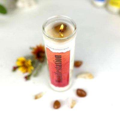 Manifestation Intention Candle shot from above, it is lit showing the stones within the wax