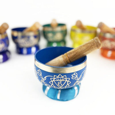 7 Chakra Colorful Singing Bowls, Pillows and Mallets , close up on blue singing bowl