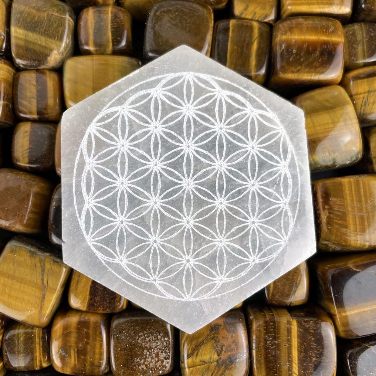 close up of selenite hexagon engraved with flower of life for engraving details