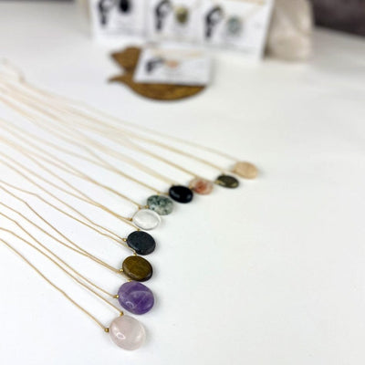 Worry Stone Necklace on Cord  spread out on a table