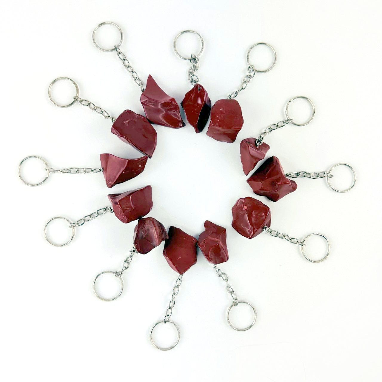 12 Red Jasper Polished Freeform Silver Toned Key Chains displayed in a circle showing size and shape variations
