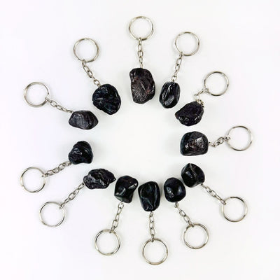 Tumbled Garnet Keychains laid out in a circle showing variations