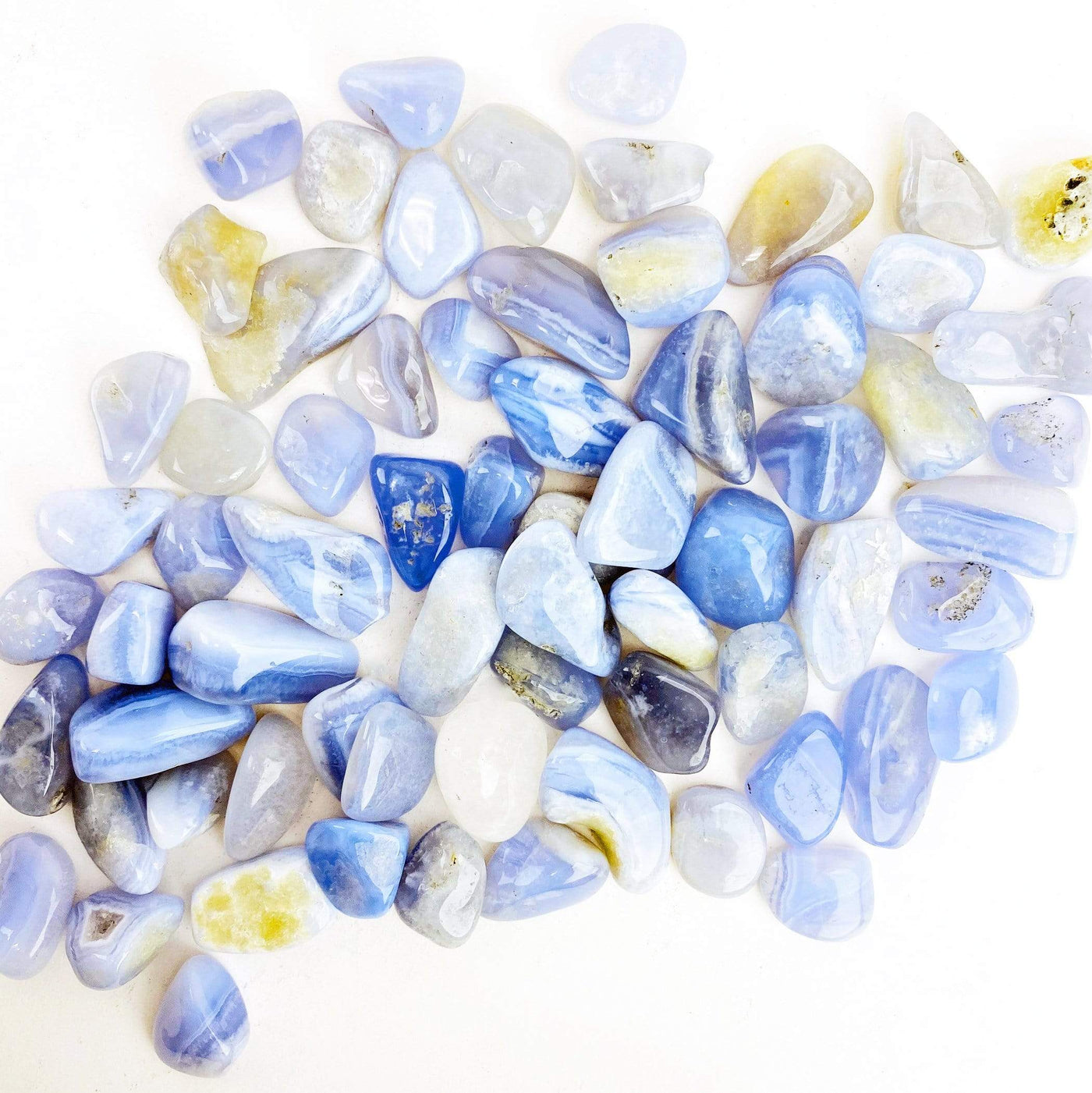 Blue Lace Agate Small Tumbled Stones spread out on a table