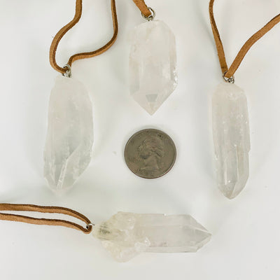 crystal points next to a quarter for size reference 