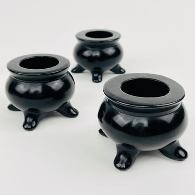 multiple cauldrons displayed to show the slight differences in the sizes 