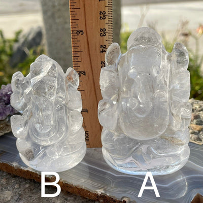 crystal quartz ganesha next to a ruler for size reference 
