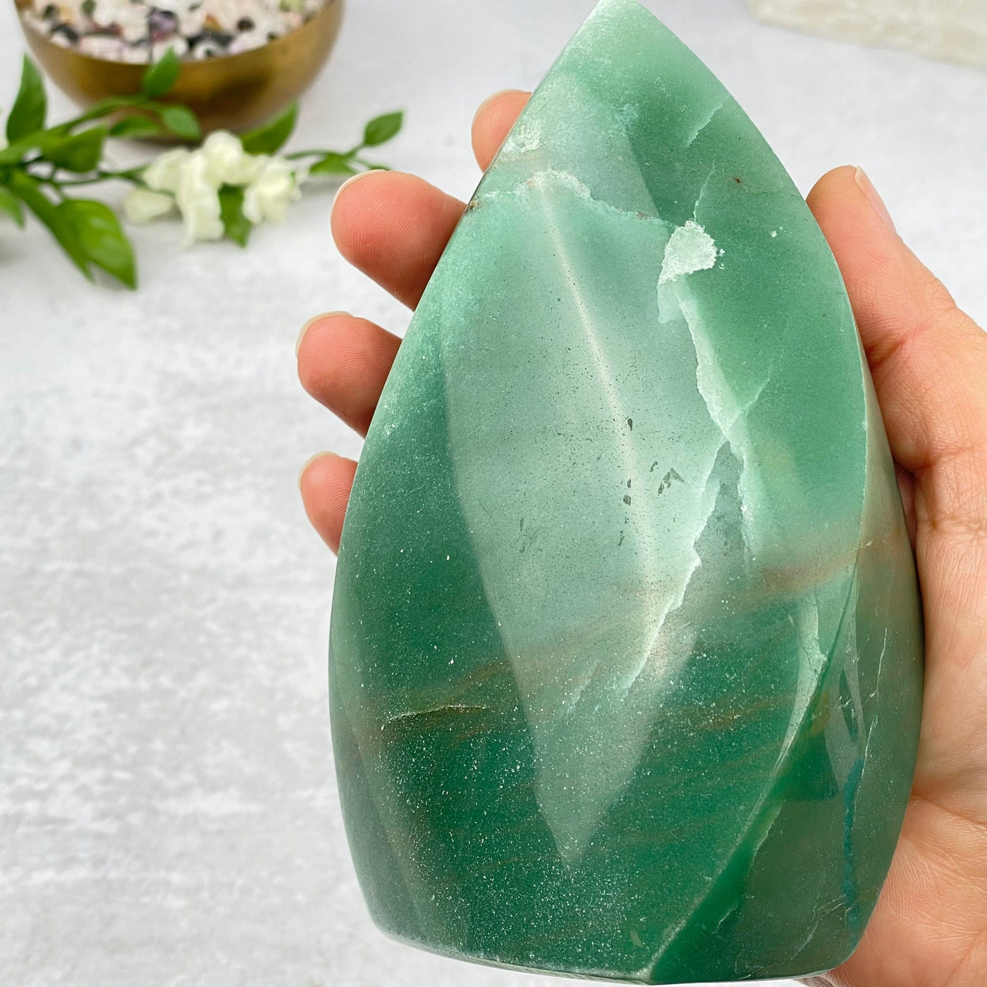 green aventurine flame tower in hand for size reference 
