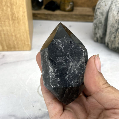 dark smokey quartz in hand for size reference