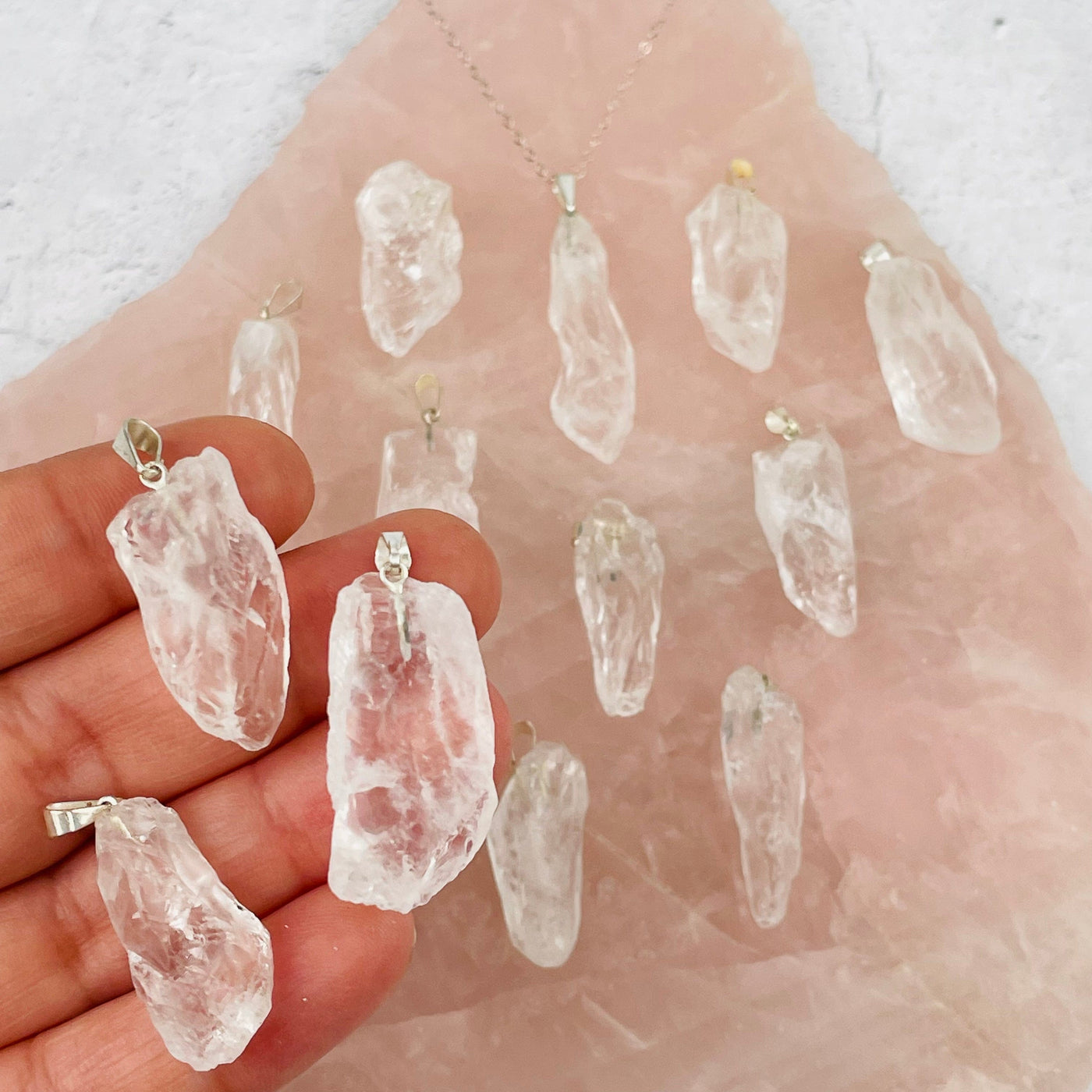Crystal Quartz - Rough Stone Pendants with Silver Plated Bail in hand for size reference 