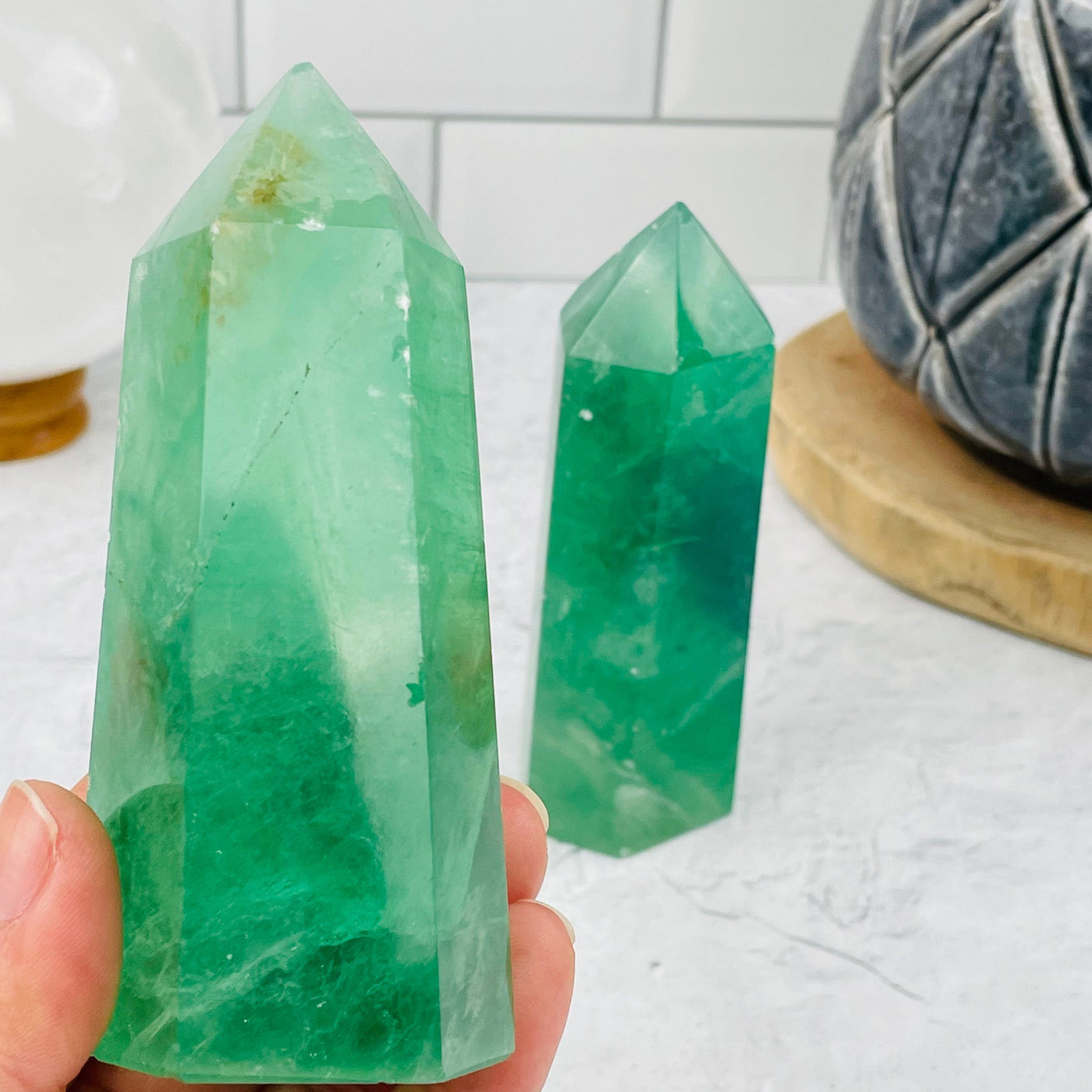 Green Fluorite Polished Point in hand for size reference 