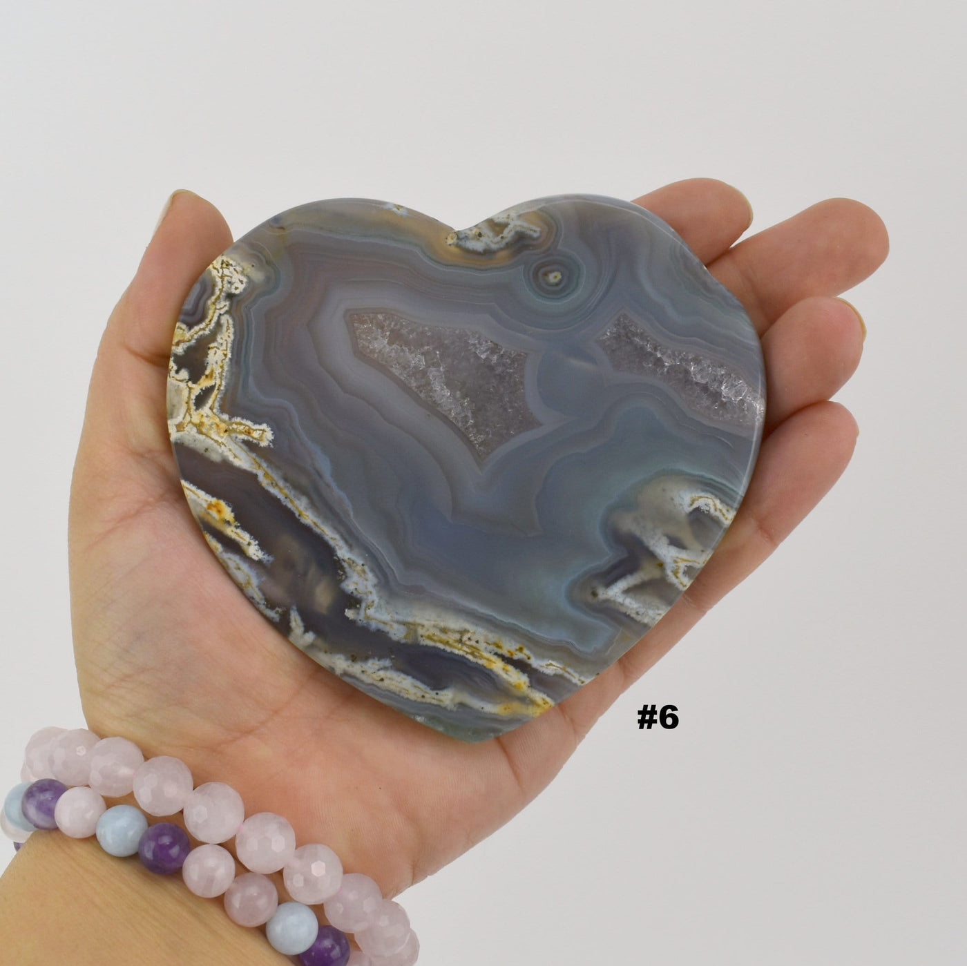 Close up of agate heart slice #6 in a hand.