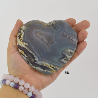 Close up of agate heart slice #6 in a hand.