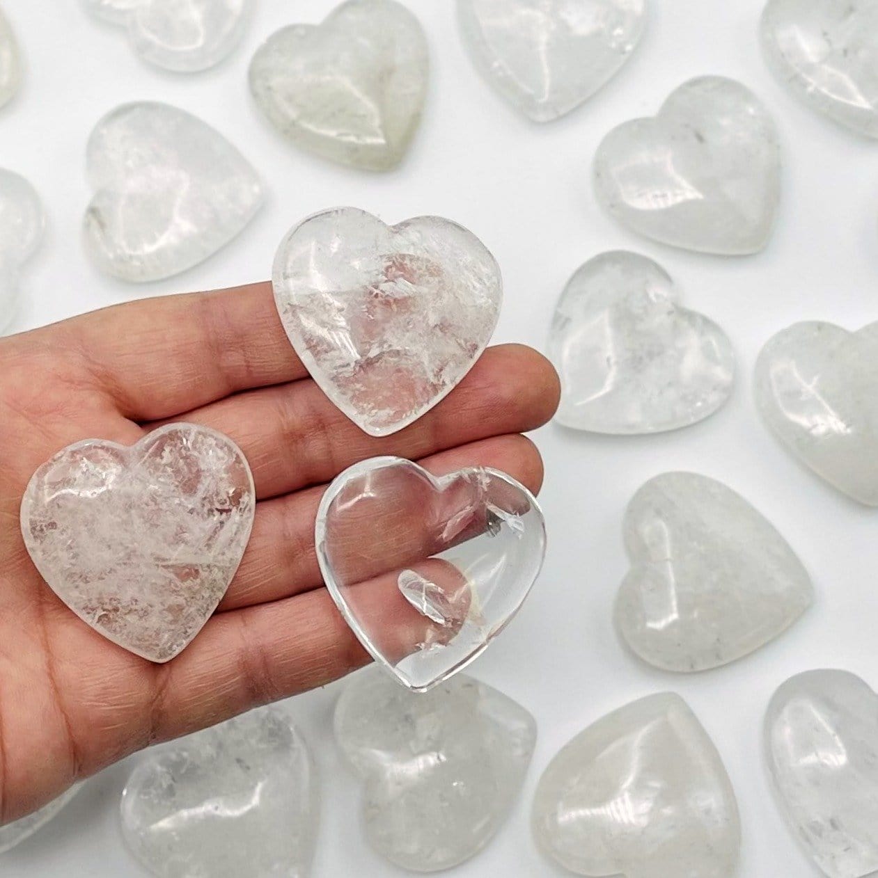 crystal quartz hearts in hand for size reference 