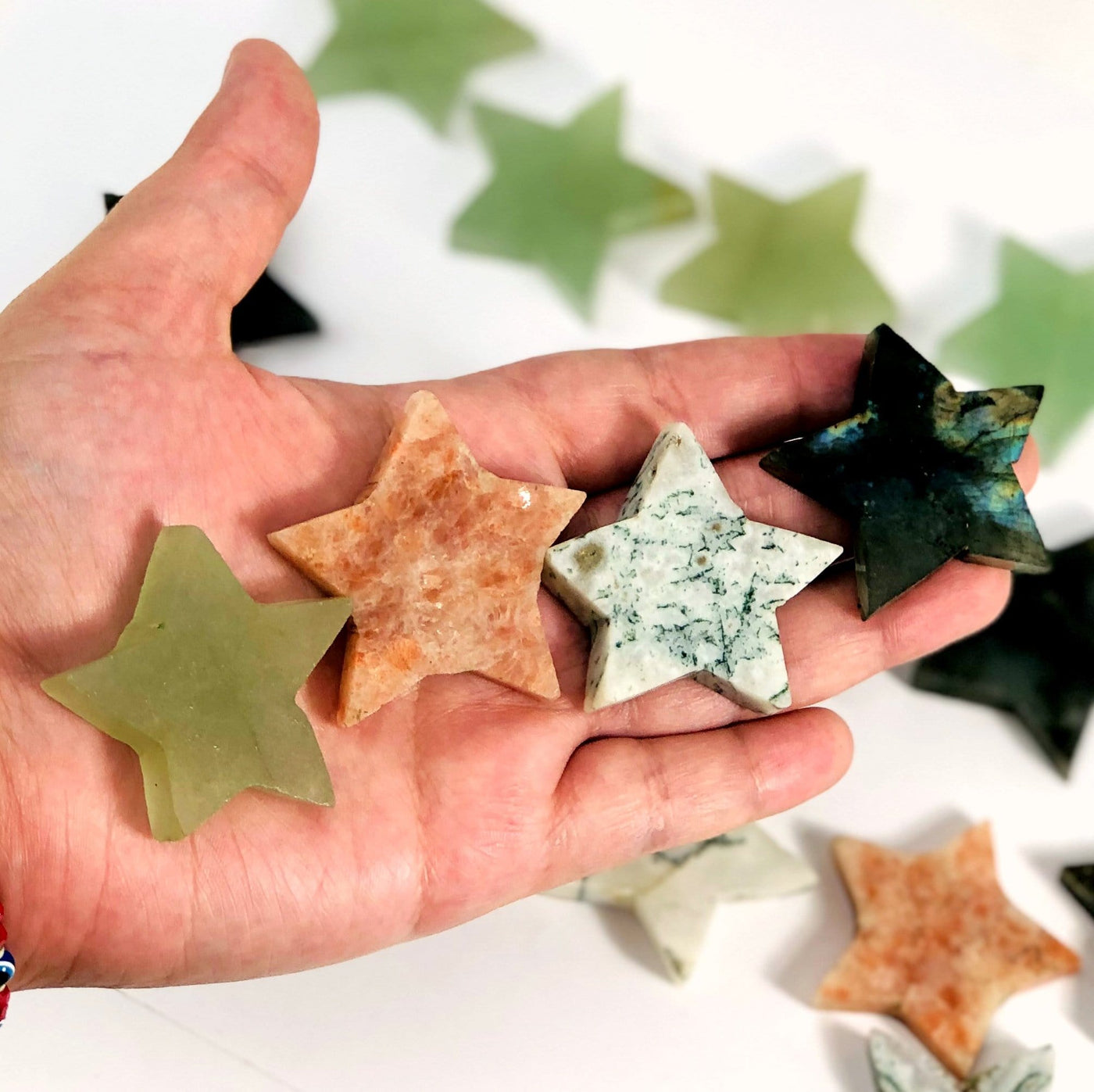 Gemstone Star Shaped Slices in a hand for size reference