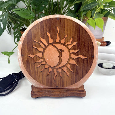 Himalayan salt lamp with sun moon design upside down sold as is from front