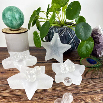 4 star selenite dishes with decorations in the background