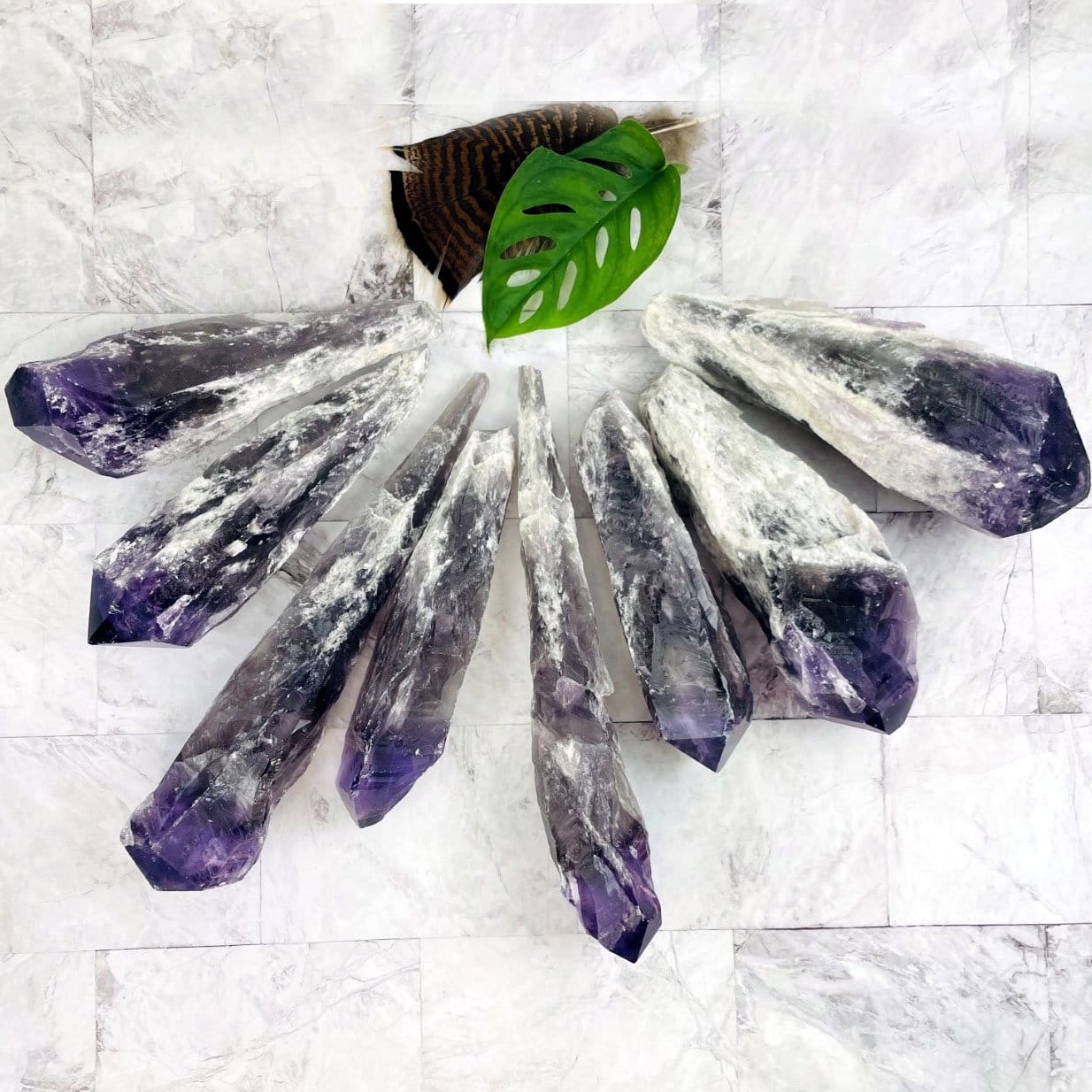 assorted elestial amethyst points on a marble background