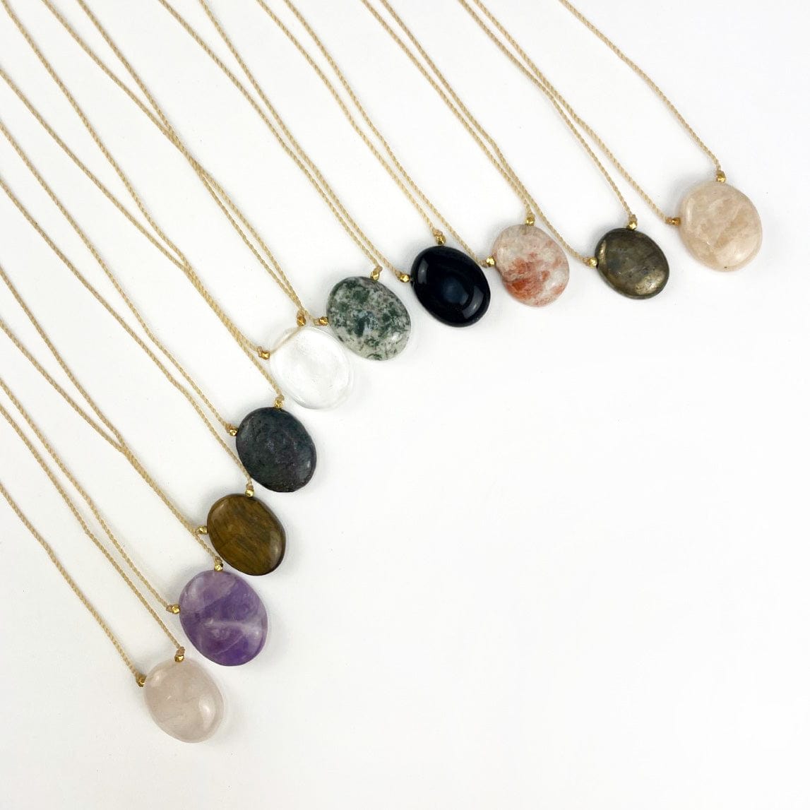 All the available Worry Stone Necklaces on Cord  on a table