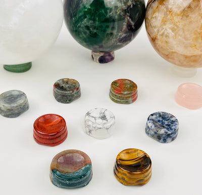 multiple crystal sphere holders displayed to show the differences in the crystal types 