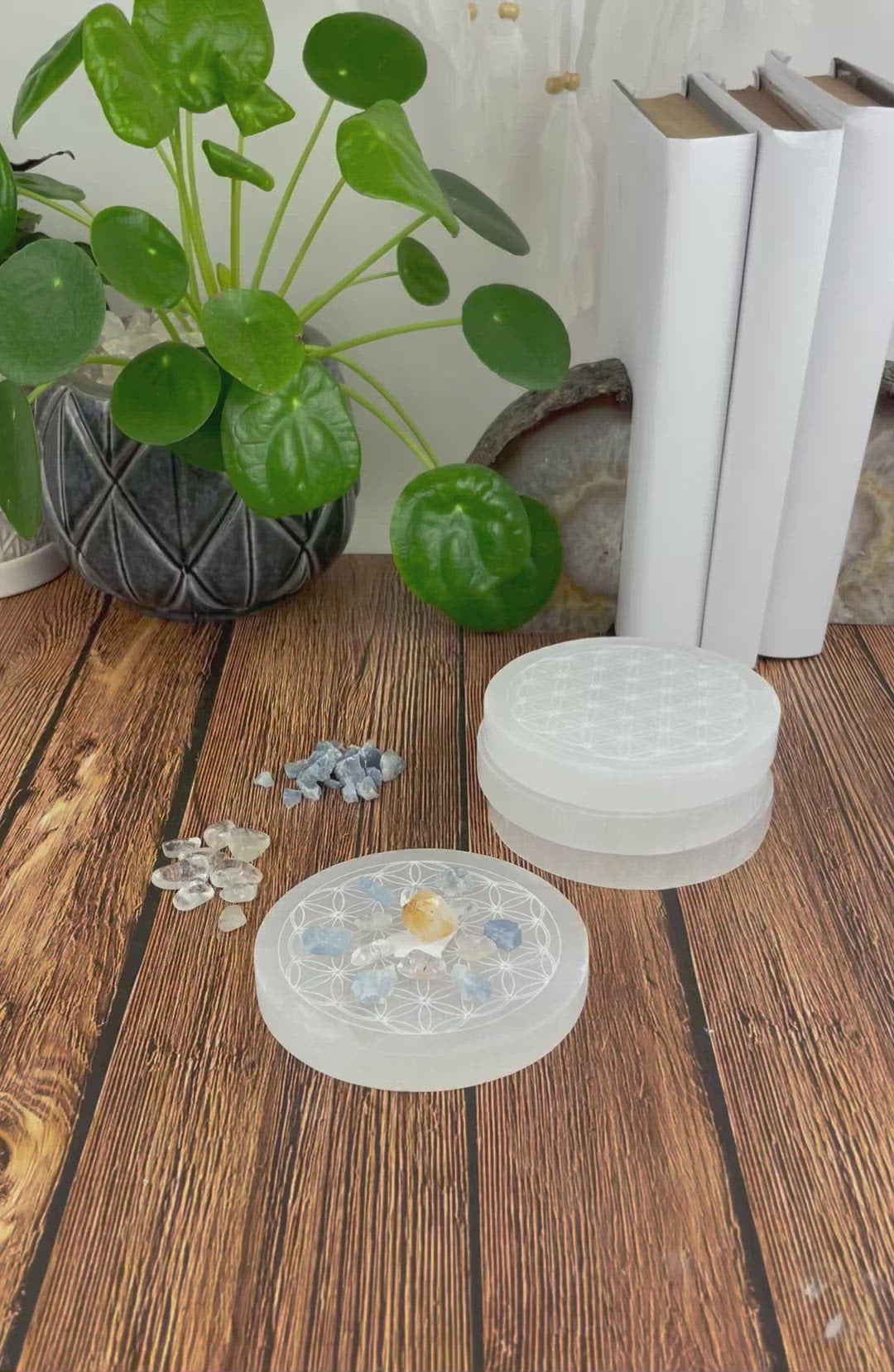 video of selenite round plate engraved with flower of life with charging stones