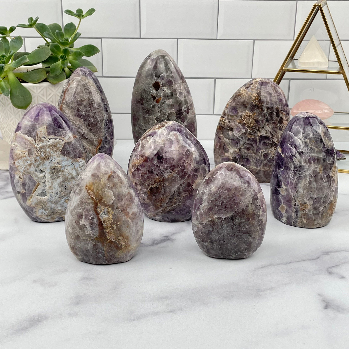 multiple chevron amethyst cut base displayed to show the differences in the sizes and color shades