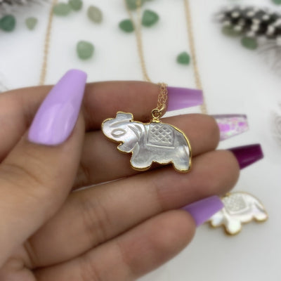Mother of Pearl Elephant Necklace in Electroplated 24k Gold in a hand for size reference