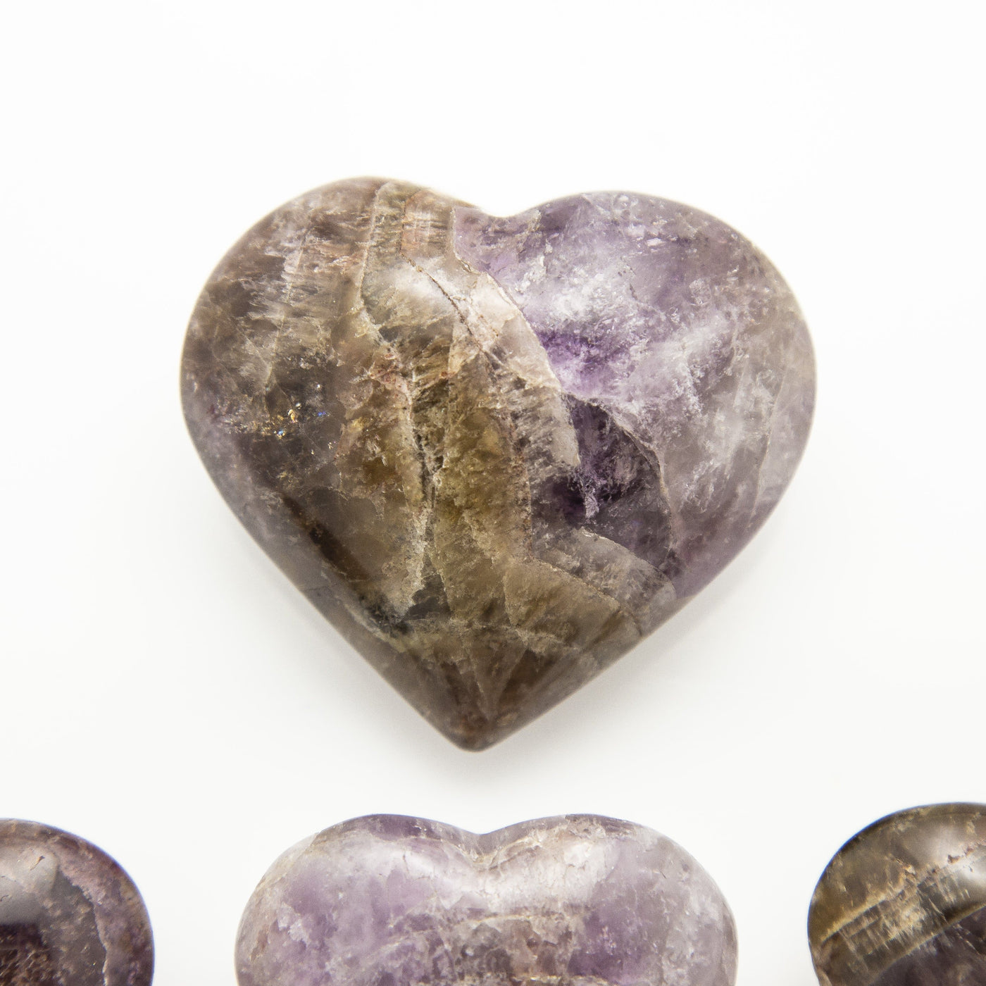close up of bigger sized seven minerals stone heart on a white background
