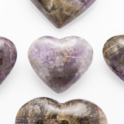 close up of smaller sized seven minerals stone heart on a white background