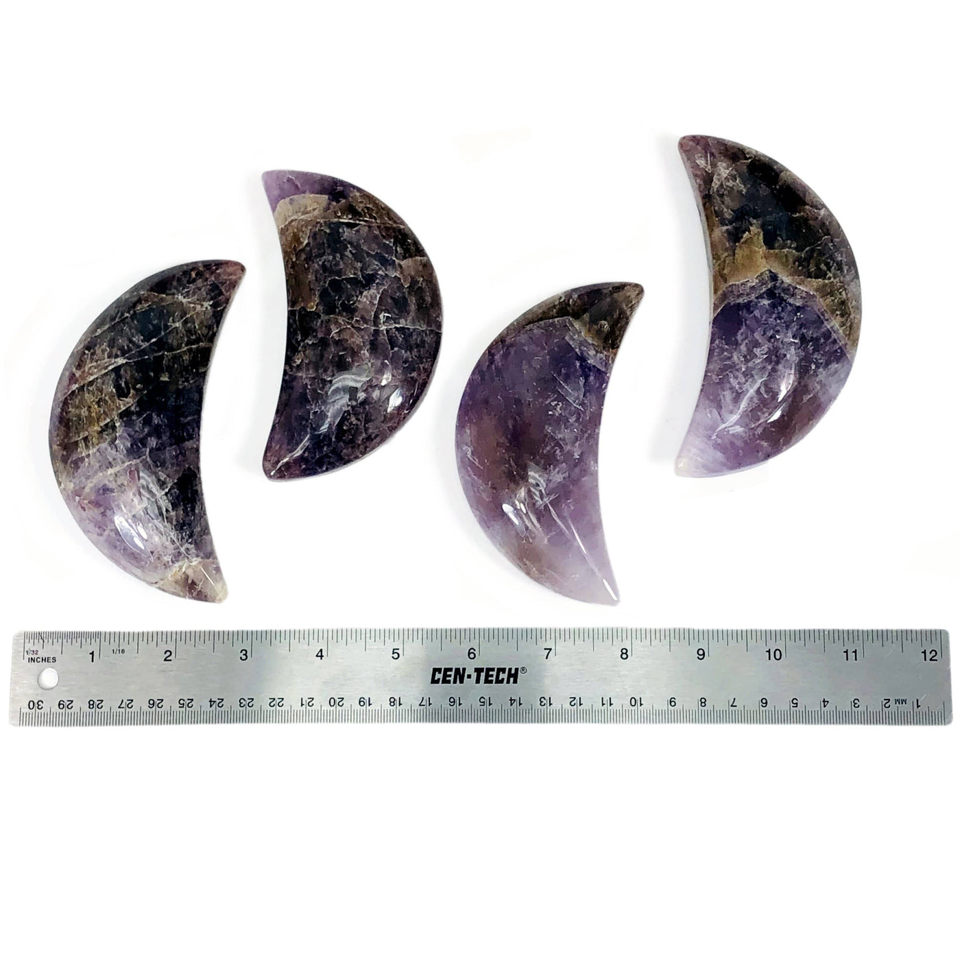 four seven minerals in one polished moons with ruler for size reference