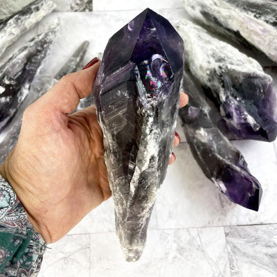 large elestial amethyst in a woman's hand