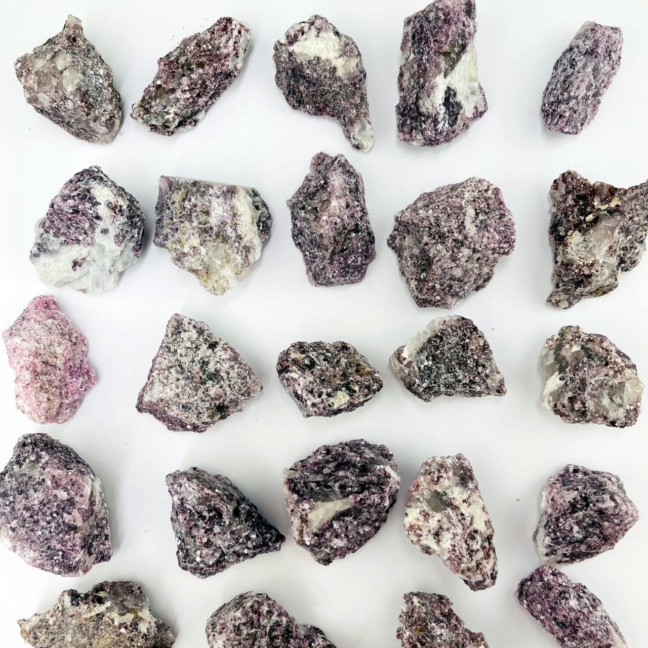 Lepidolite Natural Stones layed out on a table