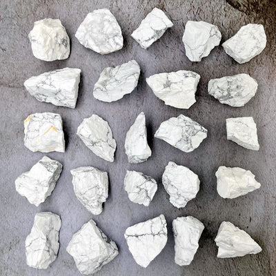 White Howlite Natural Stones laid out on a table showing assortment of shapes