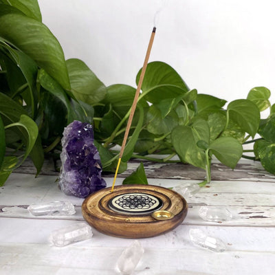 wooden incense burner with flower of life in the center displayed as home decor 