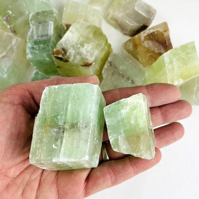 Green Calcite Stones in a hand for size