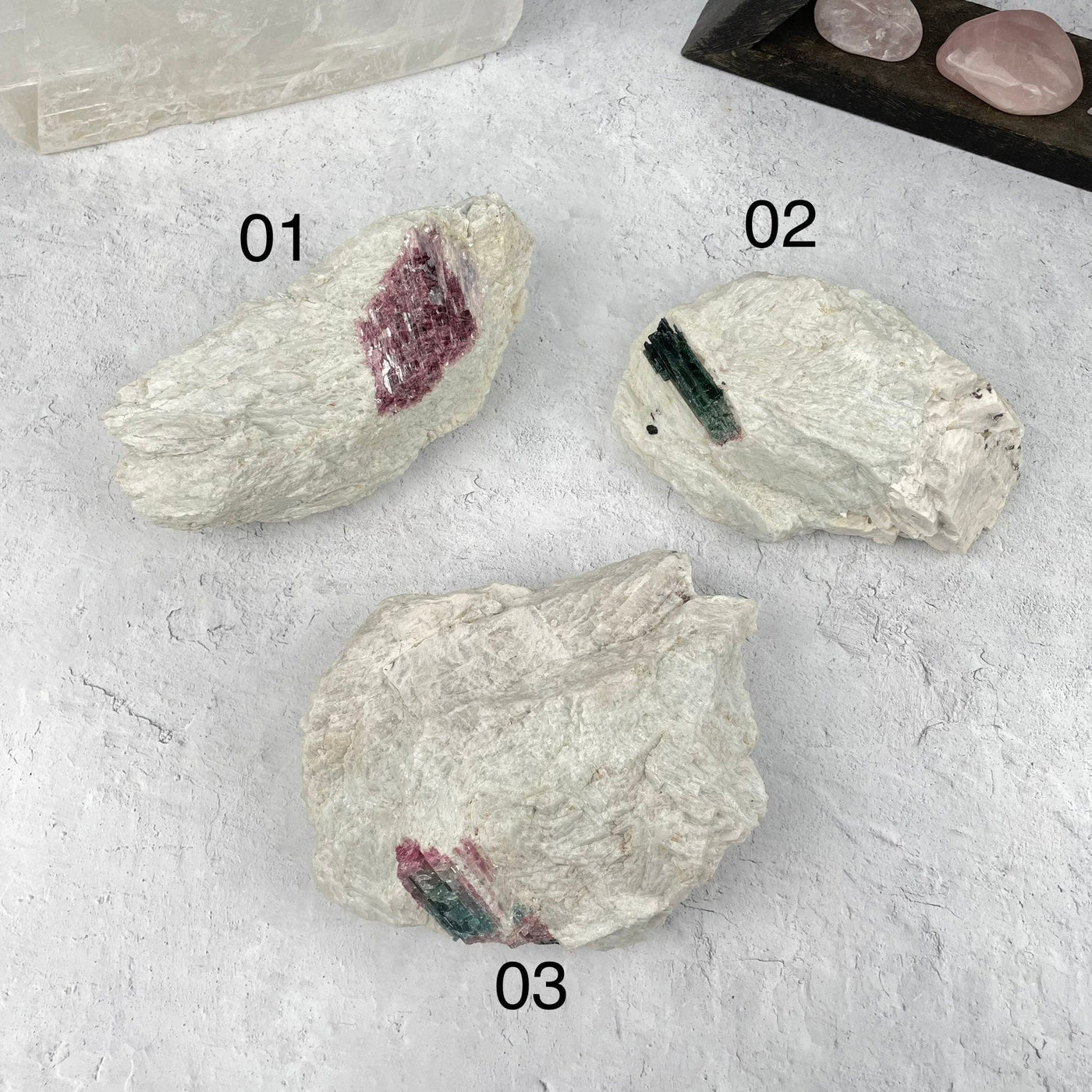 multiple Watermelon Tourmaline in Matrix clusters displayed to show the difference in the sizes and color shades