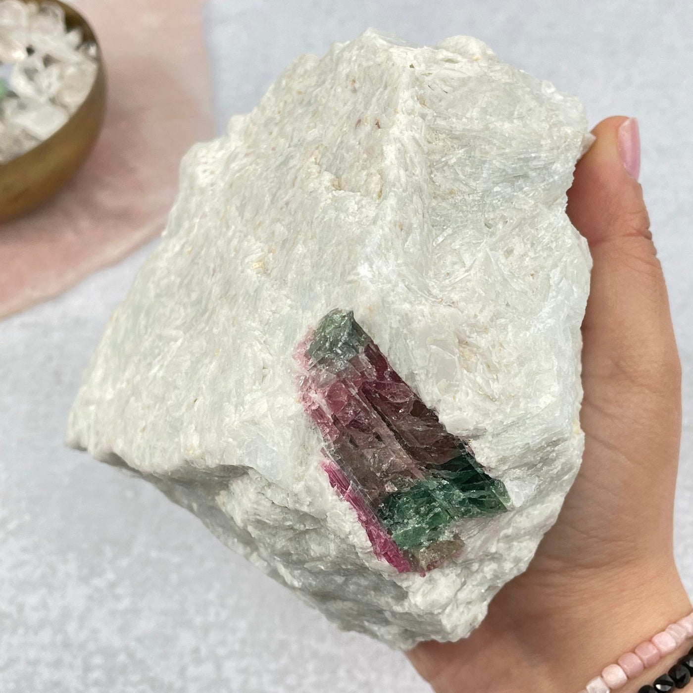 watermelon tourmaline in hand for size reference 