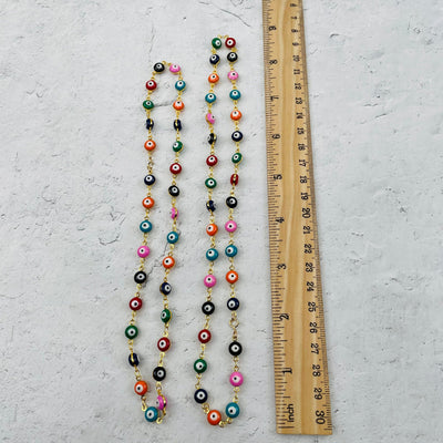 necklaces next to a ruler for size reference 