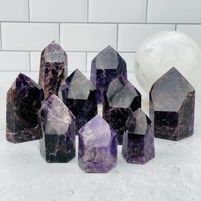 multiple deep purple amethyst points displayed to show the differences in the the sizes and color shades 