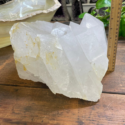 crystal cluster next to a ruler for size reference 