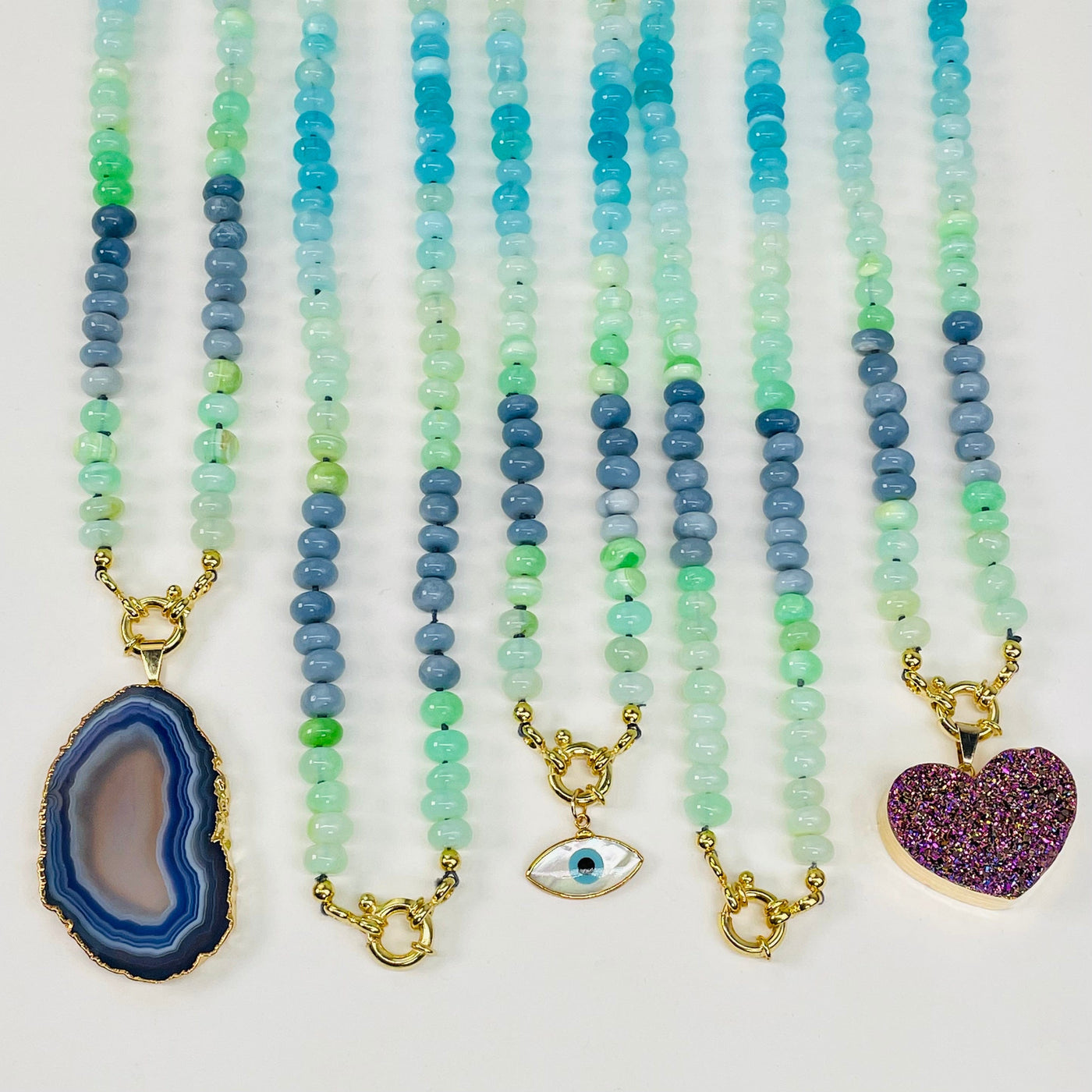 multiple necklaces displayed. some with candy charms attached 