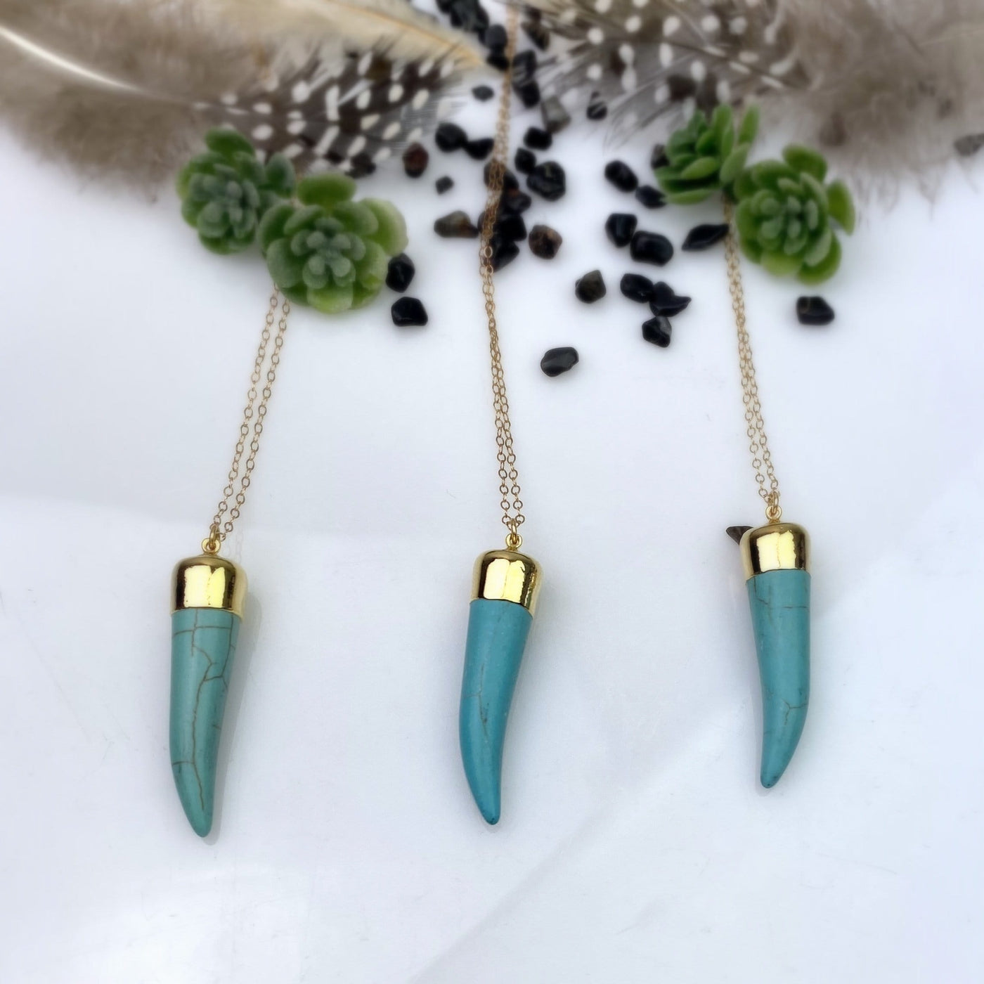 multiple Turquoise Howlite Horn Necklace in Electroplated in 24k Gold on gold fill chain 1.3mm displayed on white background showing various color shades and patterns