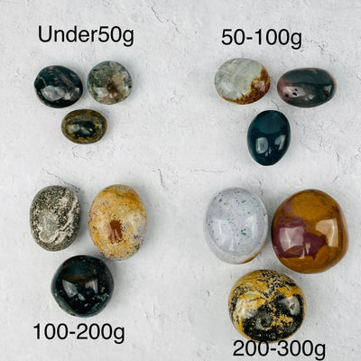 Ocean Jasper Palm Stones sold by weight. displayed next to their weight options 