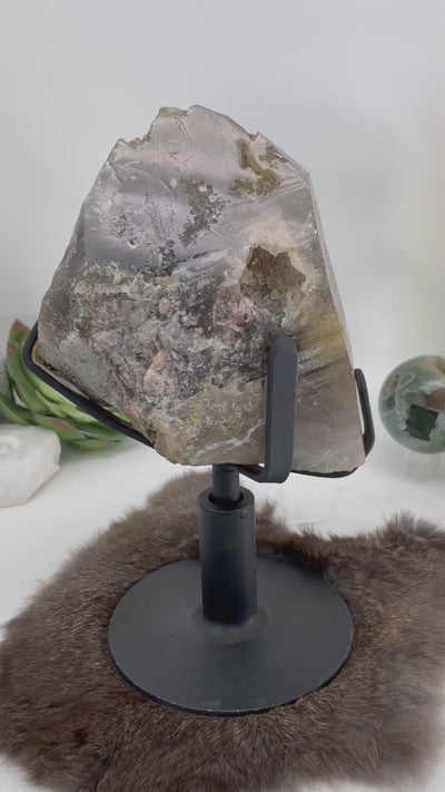 video of smokey quartz cluster spinning on its revolving metal base